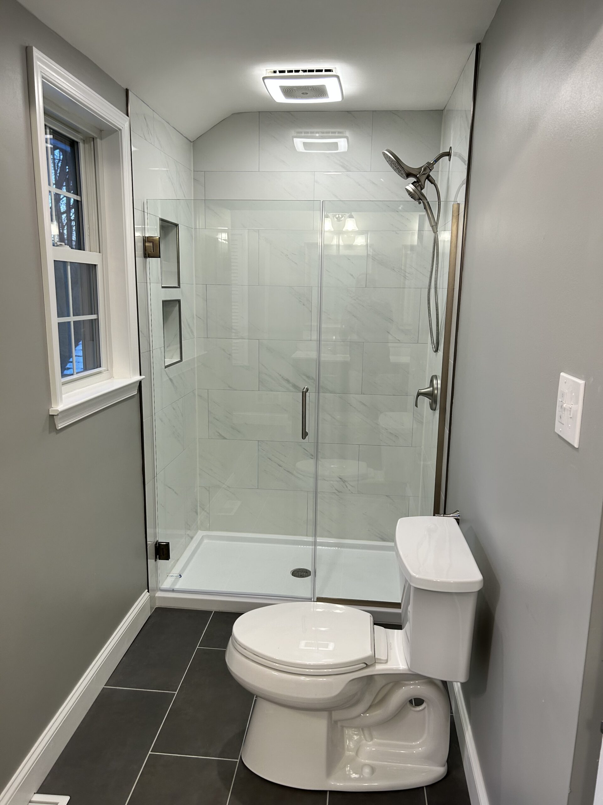 Tile shower renovation with frameless glass door